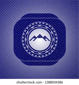 mountain icon inside badge with jean texture