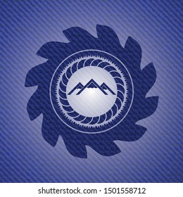 mountain icon inside badge with jean texture