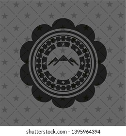 mountain icon inside black badge