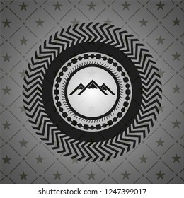 mountain icon inside black emblem