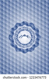 mountain icon inside blue badge with geometric background.