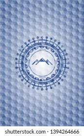 mountain icon inside blue badge with geometric background.
