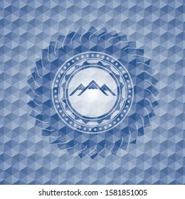 mountain icon inside blue badge with geometric background.