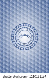 mountain icon inside blue emblem with geometric pattern background.