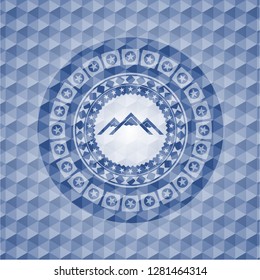 mountain icon inside blue emblem with geometric pattern background.