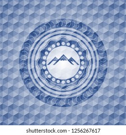 mountain icon inside blue polygonal emblem.