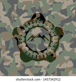 mountain icon inside camouflage emblem