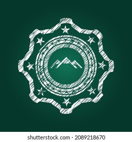 mountain icon inside chalk emblem. 