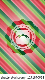 mountain icon inside christmas style badge..
