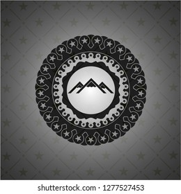 mountain icon inside dark badge or emblem