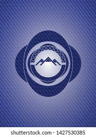 mountain icon inside emblem with jean texture