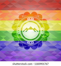 mountain icon inside emblem on mosaic background with the colors of the LGBT flag