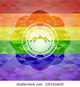 mountain icon inside emblem on mosaic background with the colors of the LGBT flag