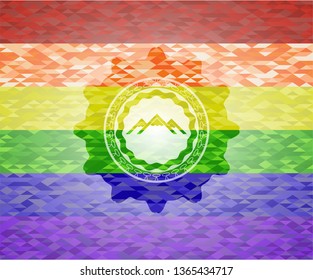 mountain icon inside emblem on mosaic background with the colors of the LGBT flag