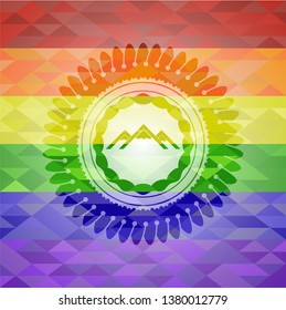 mountain icon inside emblem on mosaic background with the colors of the LGBT flag