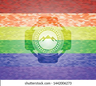 mountain icon inside emblem on mosaic background with the colors of the LGBT flag