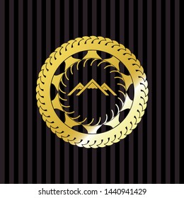 mountain icon inside gold emblem