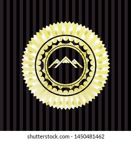 mountain icon inside gold emblem or badge