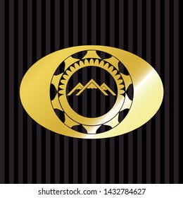 mountain icon inside golden emblem
