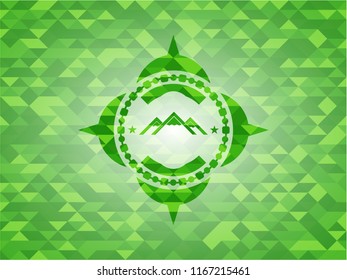 mountain icon inside green emblem with mosaic ecological style background