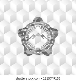 mountain icon inside grey badge with geometric cube white background