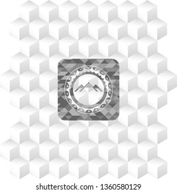 mountain icon inside grey badge with geometric cube white background