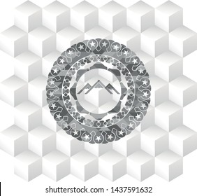mountain icon inside grey badge with geometric cube white background