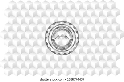 mountain icon inside grey badge with geometric cube white background