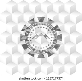 mountain icon inside grey emblem with geometric cube white background