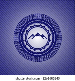 mountain icon inside jean or denim emblem or badge background