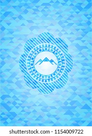 mountain icon inside light blue emblem. Mosaic background