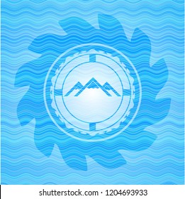 mountain icon inside light blue water badge.