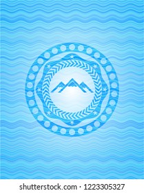 mountain icon inside light blue water emblem background.