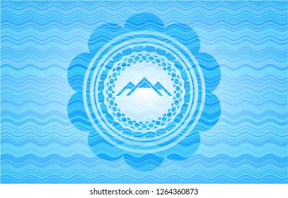 mountain icon inside light blue water wave emblem.