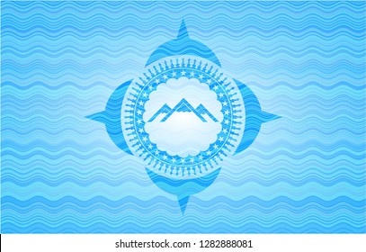 mountain icon inside light blue water badge background.