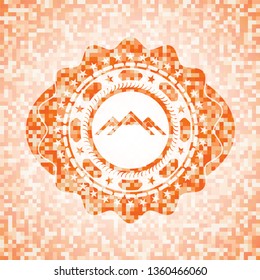 mountain icon inside orange mosaic emblem