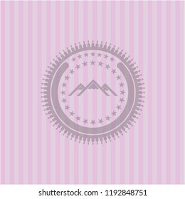 mountain icon inside pink emblem