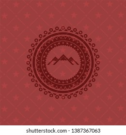 mountain icon inside red icon or emblem