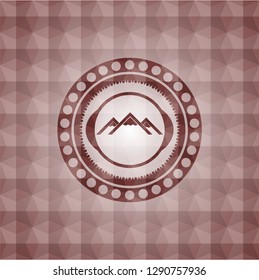 mountain icon inside red seamless badge with geometric pattern background.