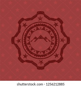 mountain icon inside retro red emblem