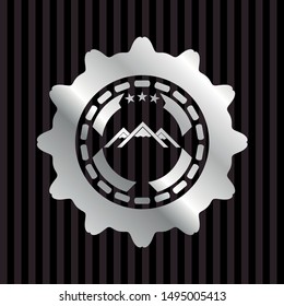 mountain icon inside silver badge or emblem