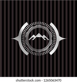 mountain icon inside silver emblem or badge