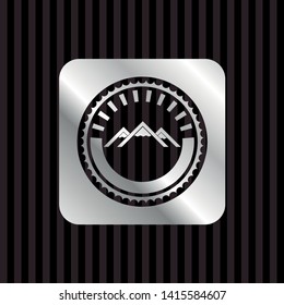 mountain icon inside silver emblem or badge