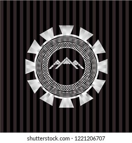 mountain icon inside silvery emblem