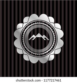mountain icon inside silvery shiny badge