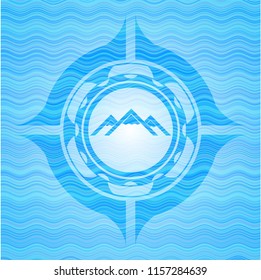 mountain icon inside sky blue water wave emblem background.