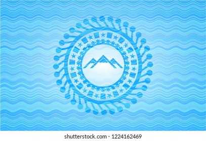 mountain icon inside sky blue water wave style emblem.