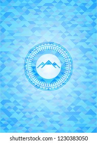 mountain icon inside sky blue emblem. Mosaic background