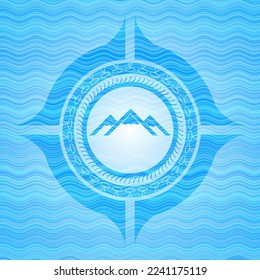 mountain icon inside sky blue water emblem background. 
