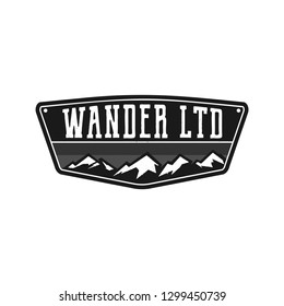 Mountain Illustration, Outdoor Adventure Logo Badge. Wander LTD Text. Vintage Hand Drawn Camping Emblem In Monochrome Style. Stock Vector Label Isolated On White Background.